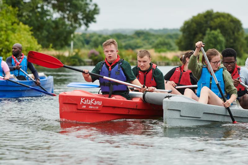 Scouts paddling katakanus on water